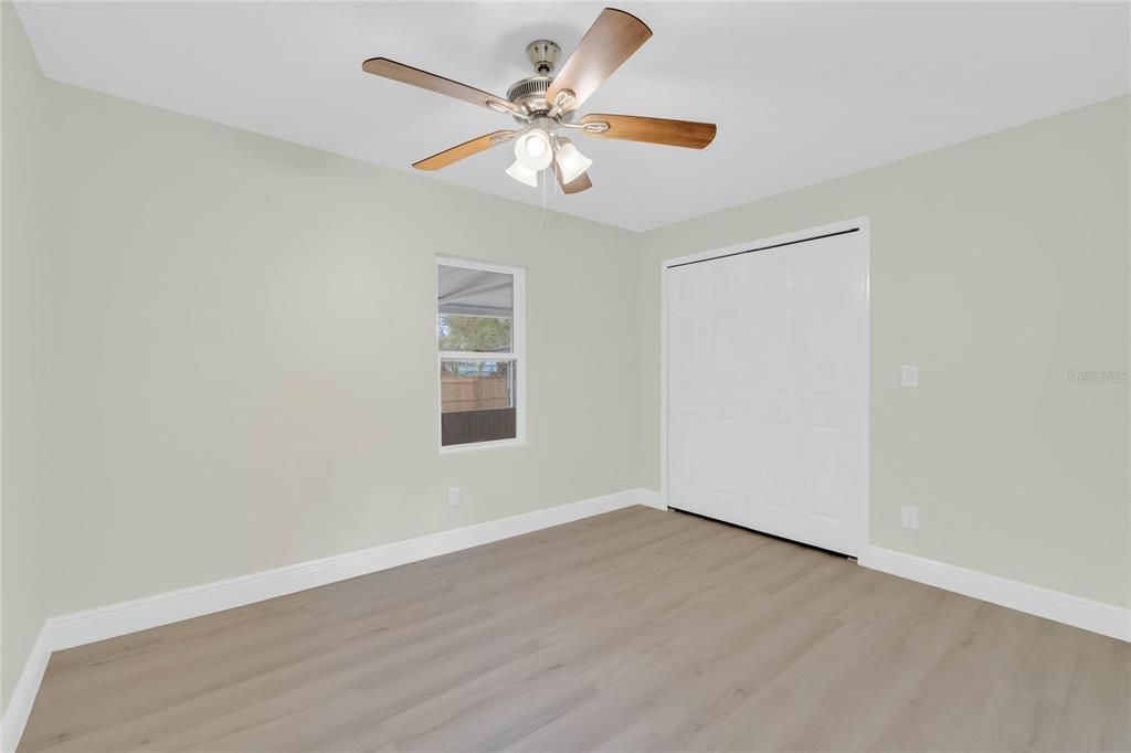 2nd bedroom, luxury vinyl plank flooring and ceiling fan.