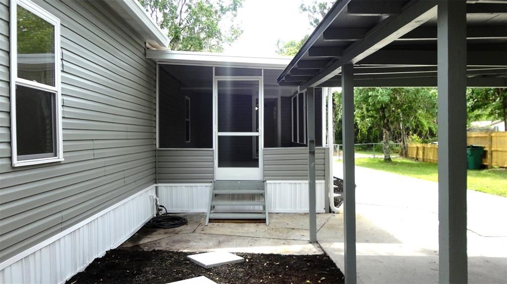 Easy access to the screen porch and house from the carport.  Can you believe how long this driveway is?