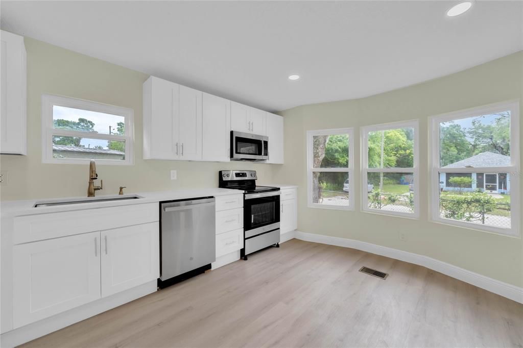 Nicely appointed kitchen with quartz countertops, all new applicances and cabinetry.  Extra space to put a breakfast table.