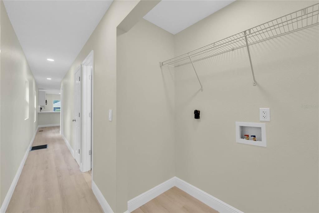 Inside utility space located conveniently in hallway between the two bedrooms.