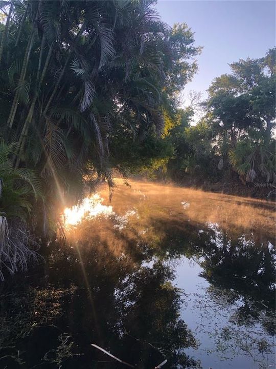 Mornng View of the Canal with the sun reflecting off the water and mist in the air!!! Beautiful and imagine your morning coffee on the deck with this view!!