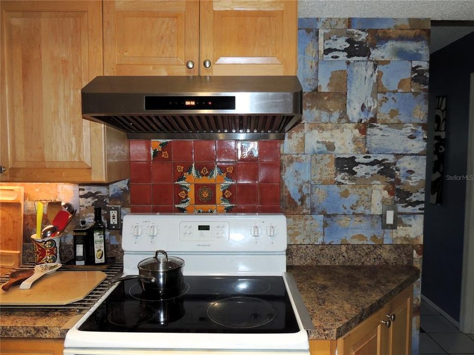 Range with Hood and please note the Tile Back Splash to the right of the range and the Tile behind the Range