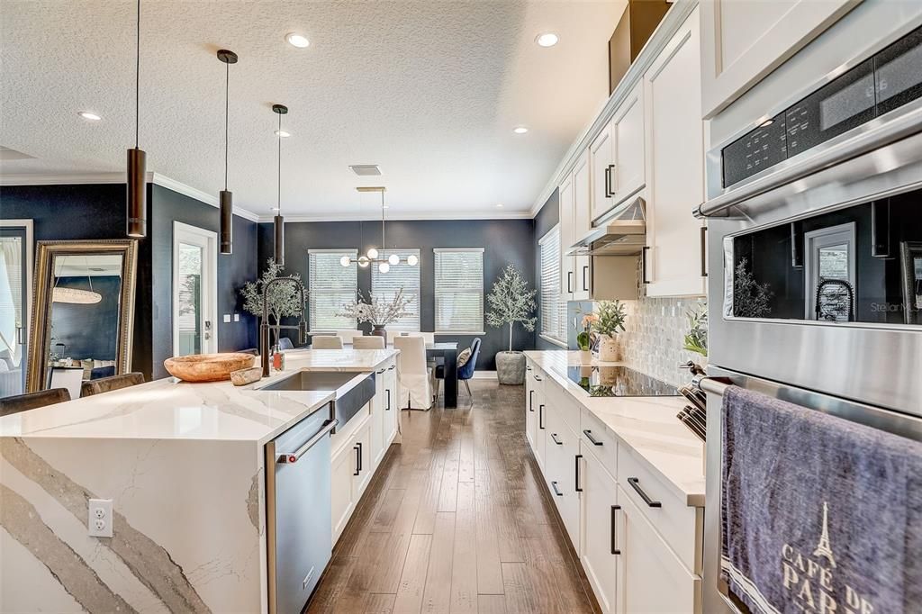 LEVEL 7 QUARTZ COUNTERTOPS in the kitchen, KITCHEN ISLAND WATERFALL DESIGN, NATURAL GAS BOSCH INDUCTION COOKTOP, EXTENDED KITCHEN ISLAND, GOURMET KITCHEN FEATURES