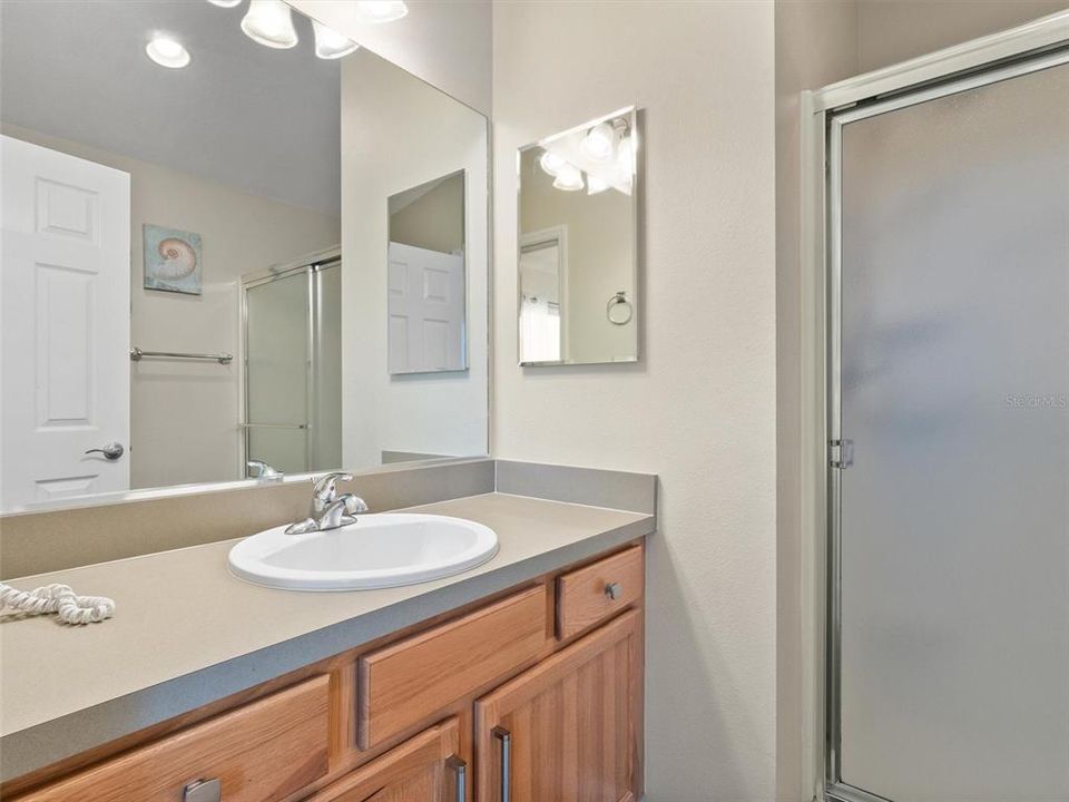 En-suite master bath has step in shower and large vanity
