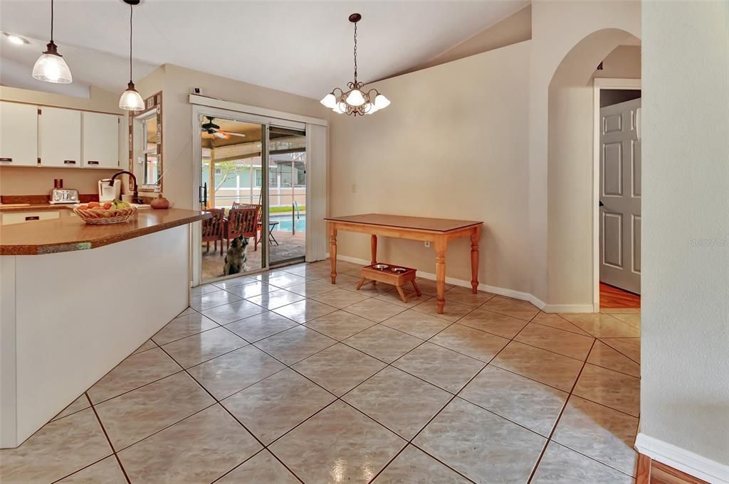 Eat in area in kitchen with door to screened patio/pool