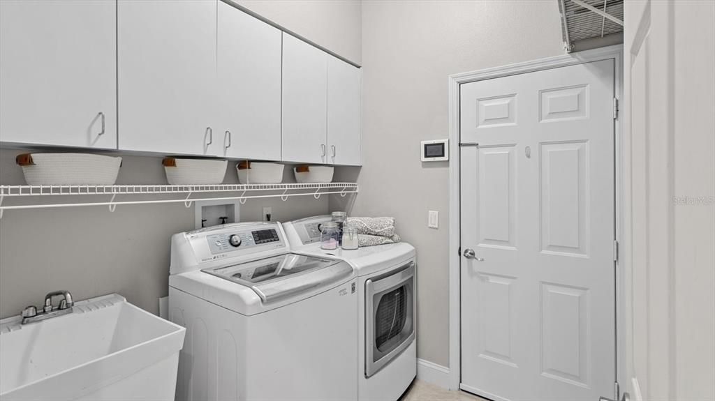Laundry with storage and utility sink.