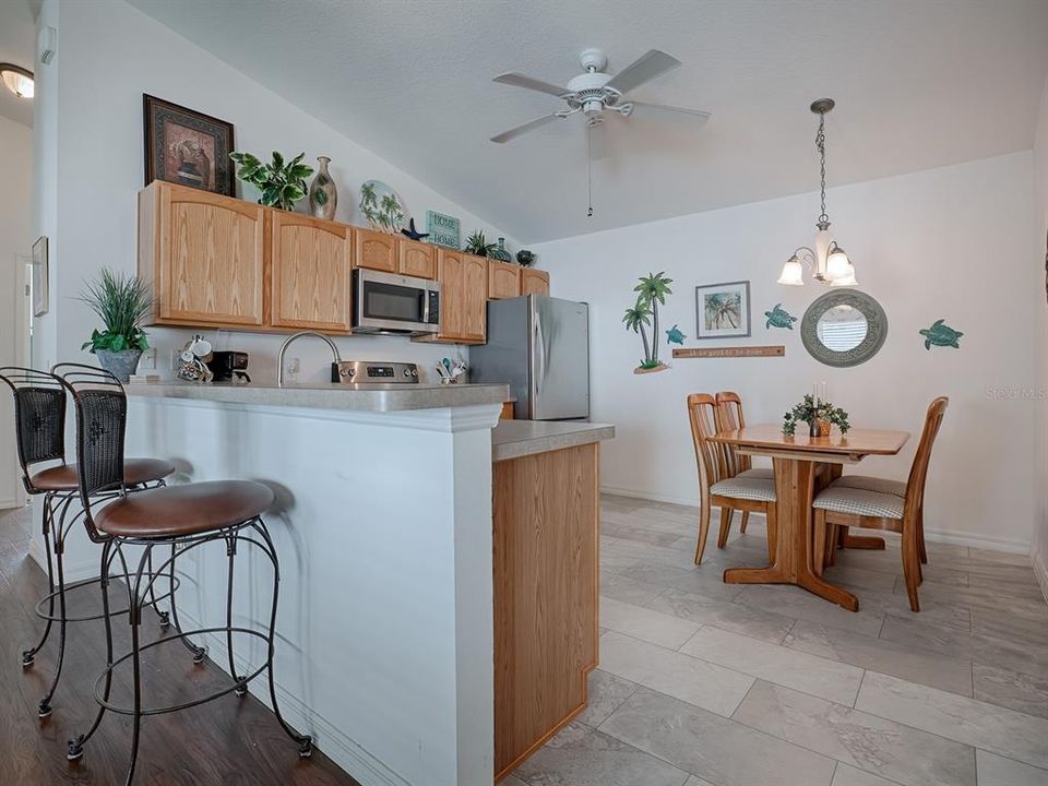 GORGEOUS FLOORING IN THE KITCHEN, A BREAKFAST BAR AND AN EAT-IN KITCHEN DINING NOOK