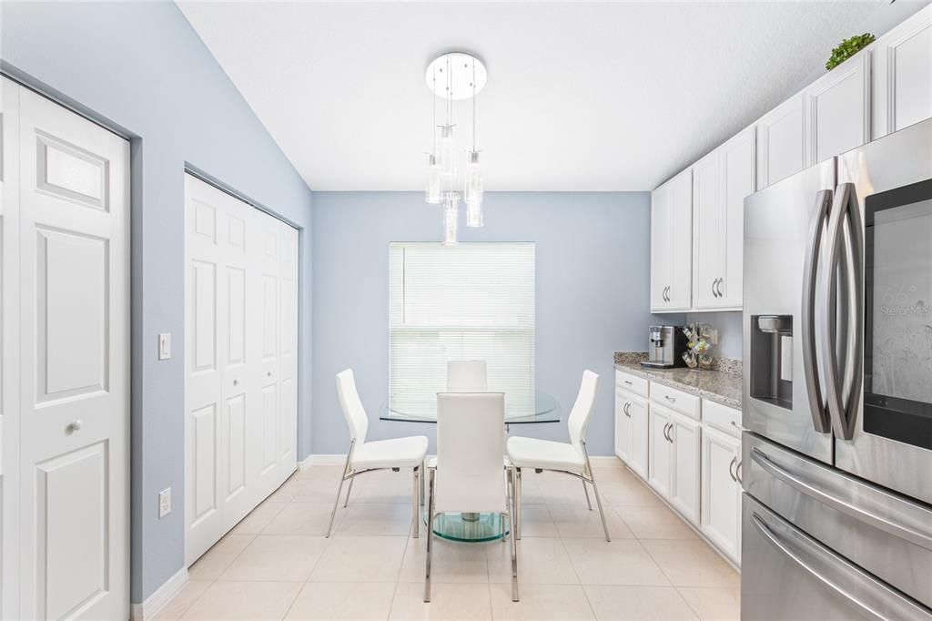 Kitchen in main house with view of extra counter space and doors to pantry and laundry area