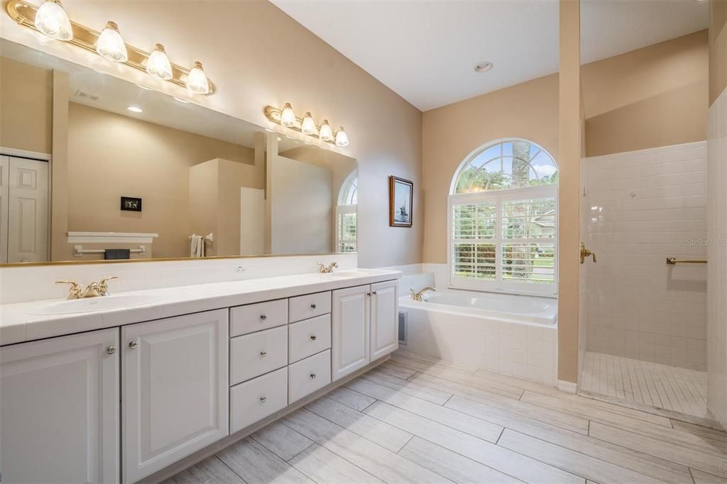 Walk-in shower with soaking tub and double vanity for additional storage