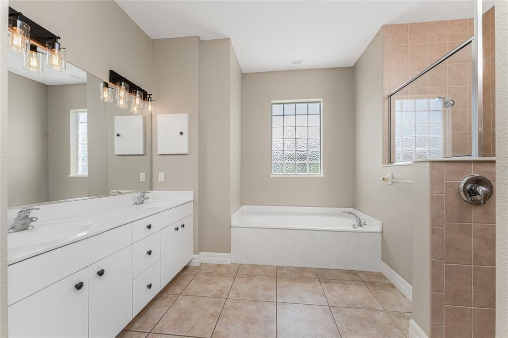 Master bath features a garden tub and Roman Shower.