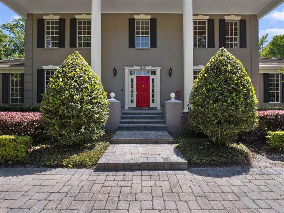 A classic red front door greets you upon arrive.