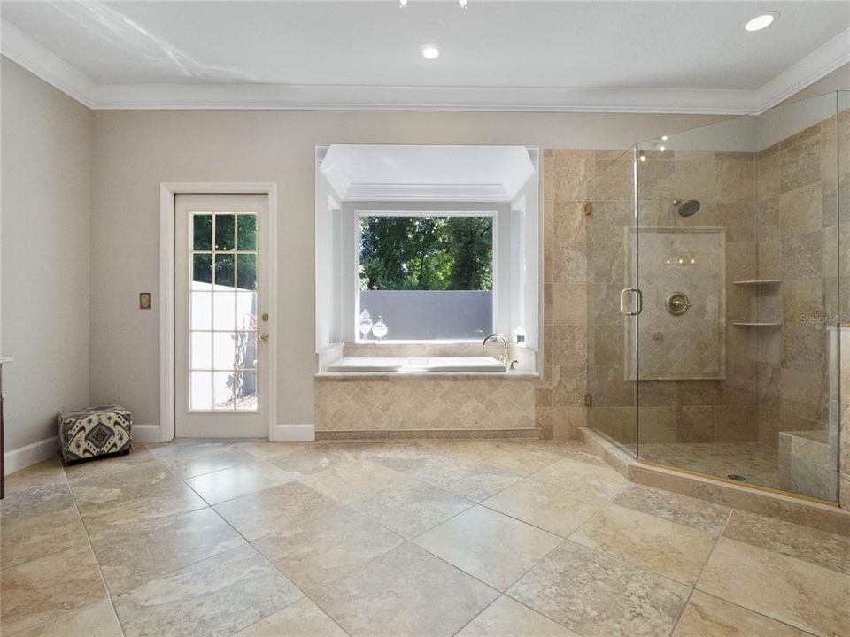 Enjoy a soaking tub and frameless glass-enclosed shower.