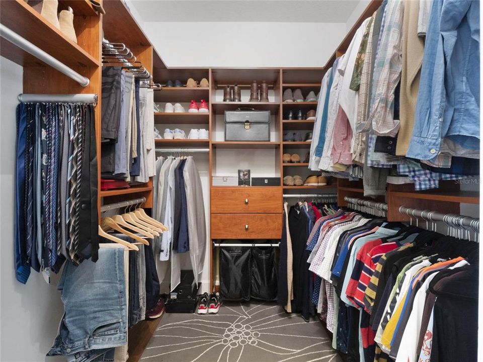 Dual walk-in closets with organizational systems ensure ample storage and convenience.