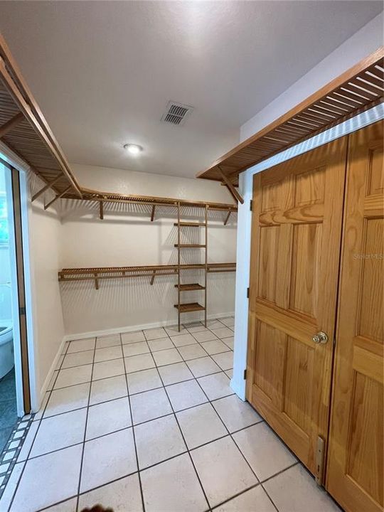 Spacious laundry room with plenty of cabinets and Hanging racks