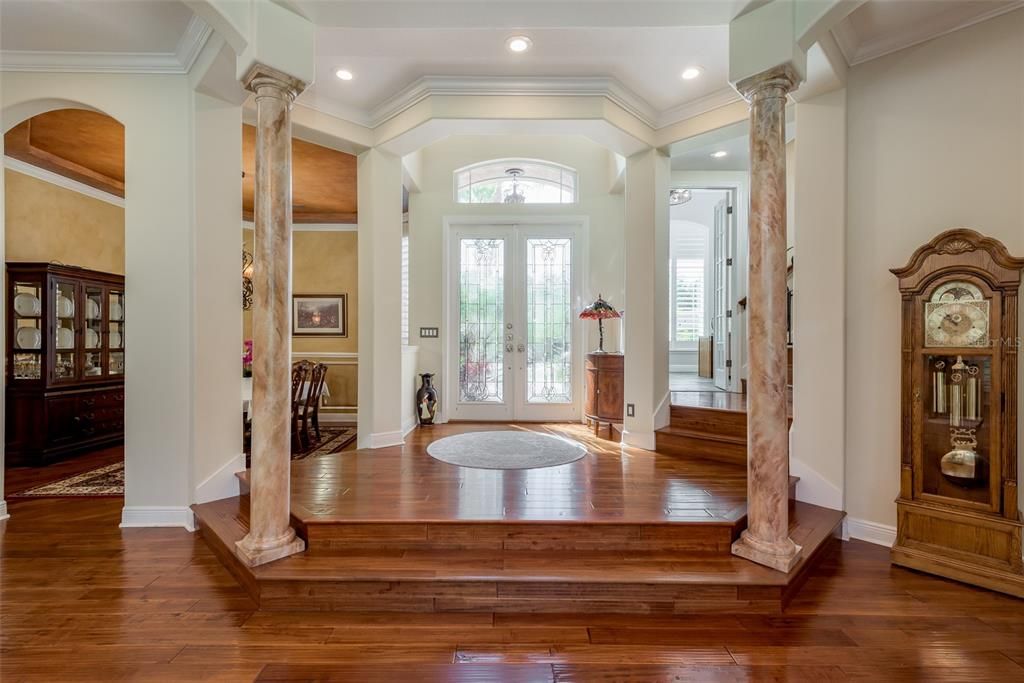 grand entryway with hand wood scraped flooring.