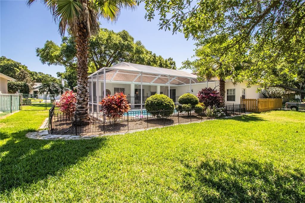 Spacious back yard, decorative aluminum fencing, wooden fencing with pool pump and A/c unit. Double-gate for backyard entrance on left