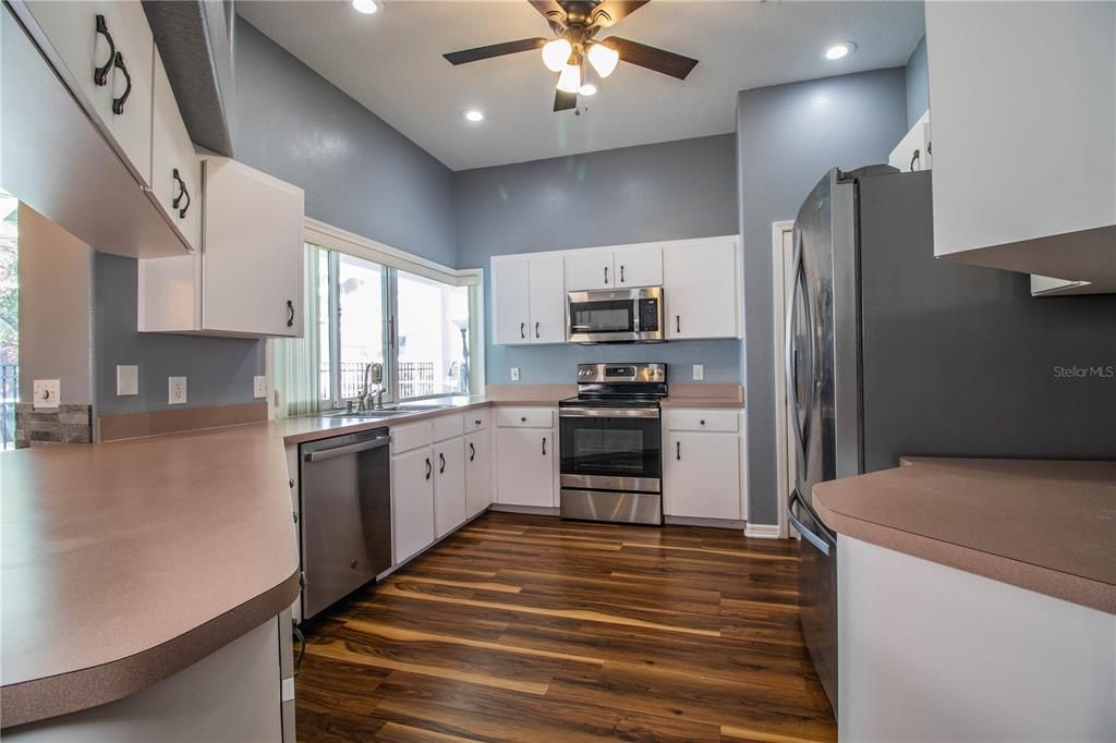 Kitchen with Stainless Steel appliances.  Large pass through window to pool entertainment area.