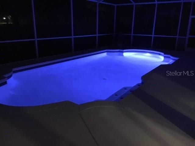 Pool with night lights and aluminum fence