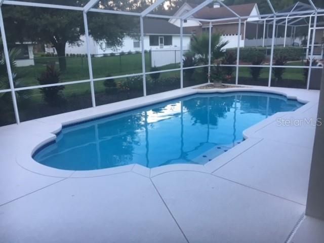 Pool with angle showing covered entertainment area