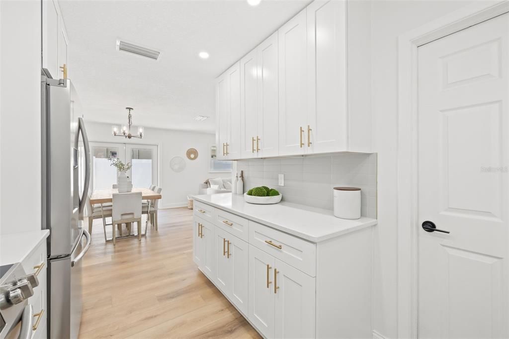 Door Leads to Utility Room for Washer & Dryer