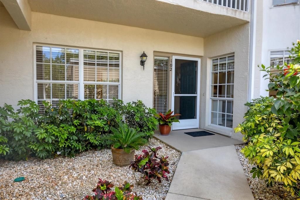 Front entry into your new home!! Screen door allows for great ventilation year round if desired. Windows on the right of entry door brings sunlight to your breakfast room for your morning coffee! Enjoy your lovely outdoor gardens from with in!