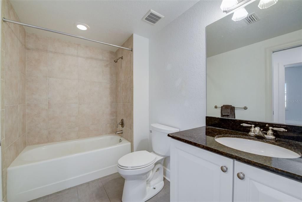 Hall Bath with Stone Counter Tops, Tub/Shower Combo