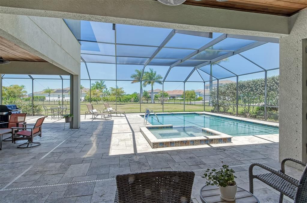 THE SCREENED POOL CAGE CREATES SHADE & PRIVACY