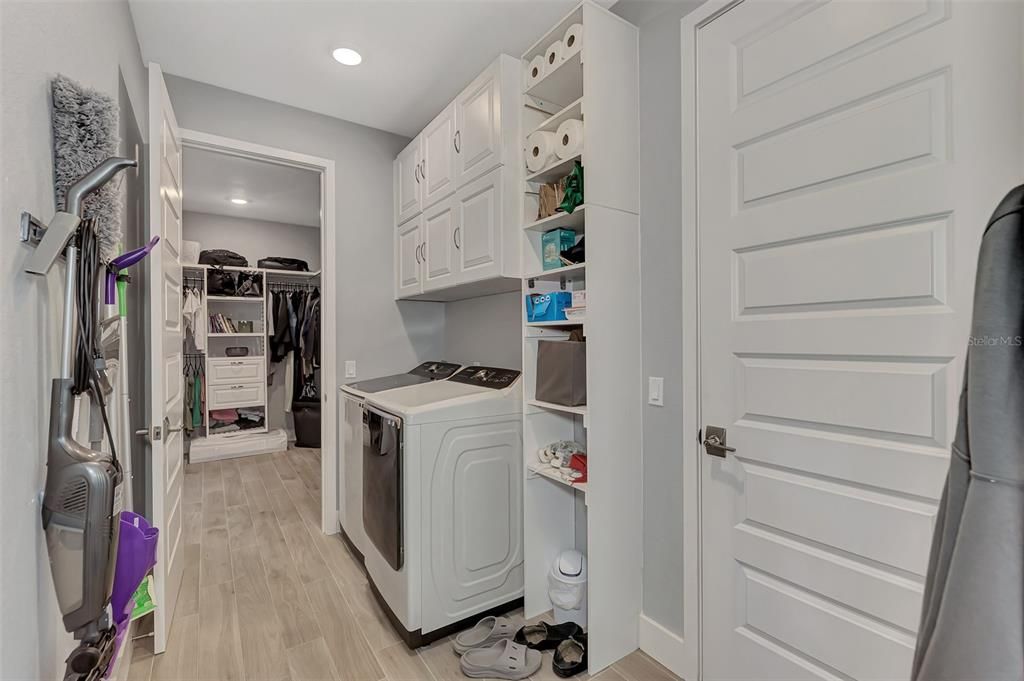 Laundry room connected to primary bedroom closet