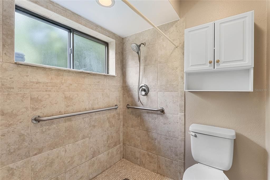 Spacious walk-in shower with natural light!