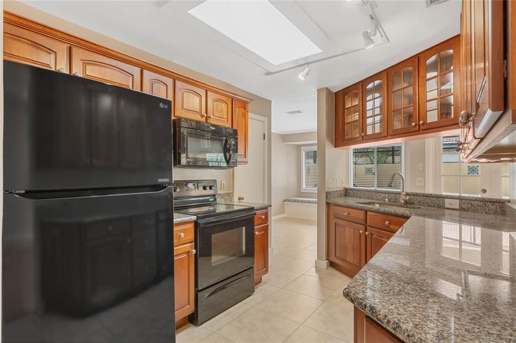Upgraded kitchen with newer granite counters and glass door cabinetry!