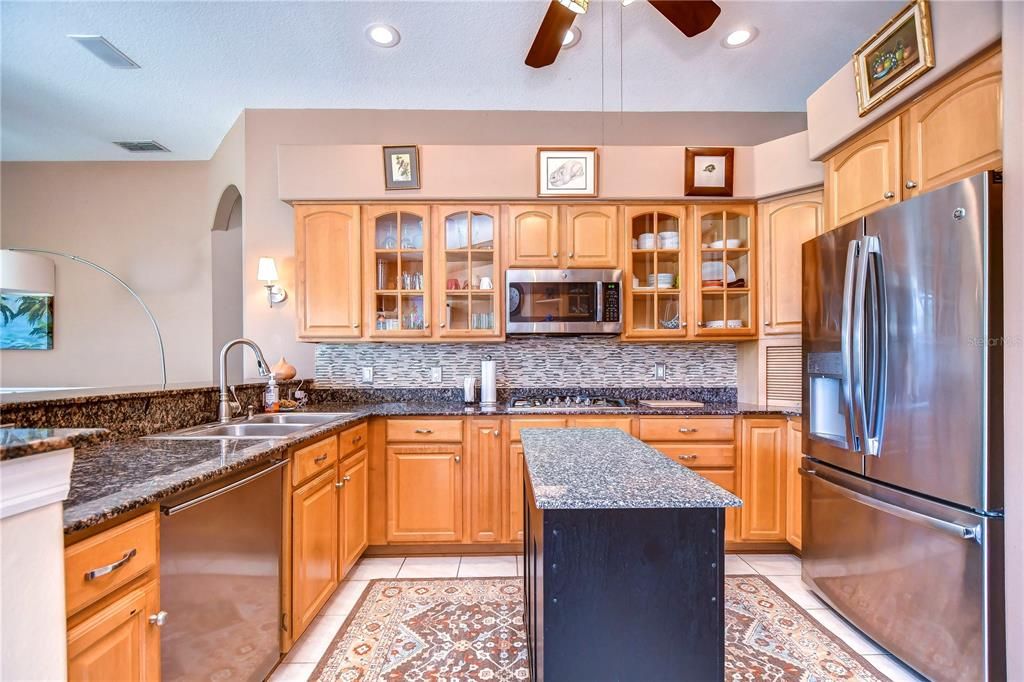 Stainless steel appliances including a gas cooktop and double ovens, and granite countertops!