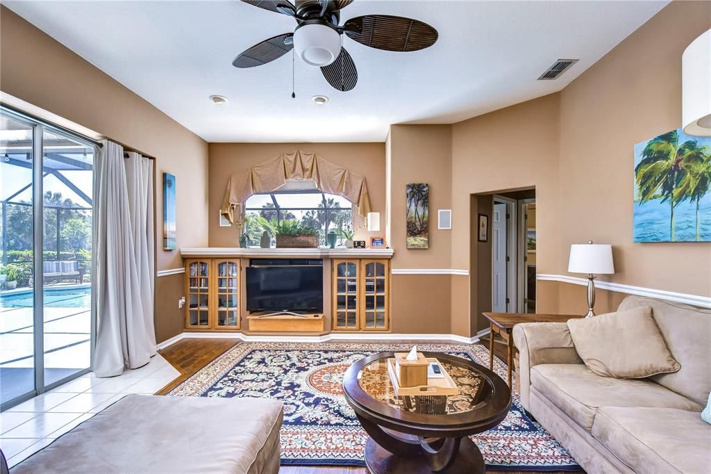 Family room with built-in cabinetry and double sliders to the lanai!