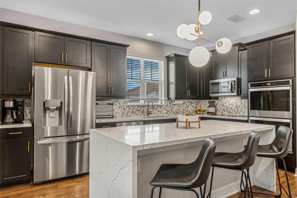Stainless steel appliances, upgraded lighting, gold touches