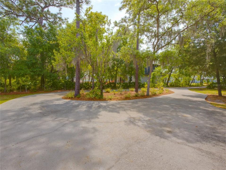 Circular driveway leads to back/side of house.