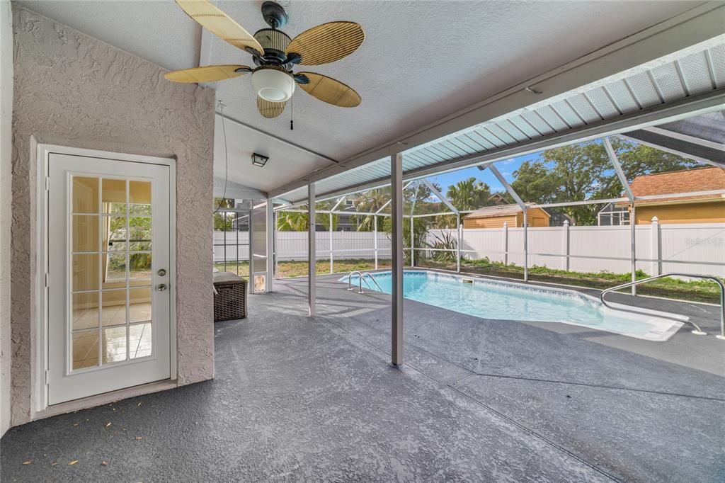 The COVERED LANAI is the perfect place to relax poolside, SCREENED for your comfort and the backyard is FENCED!