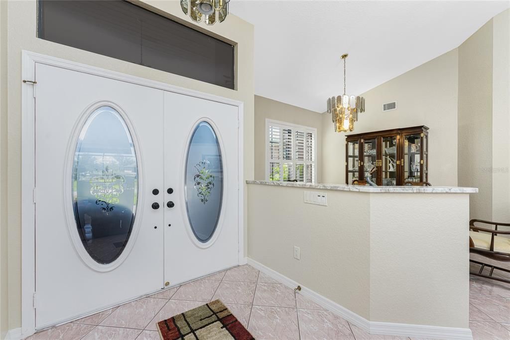 Double door entry to home with guest coat closet