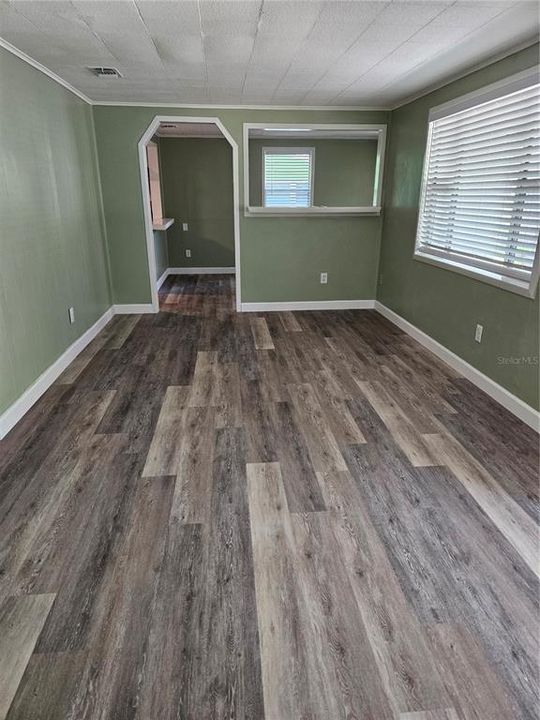 Living room with new vinyl flooring and new baseboards
