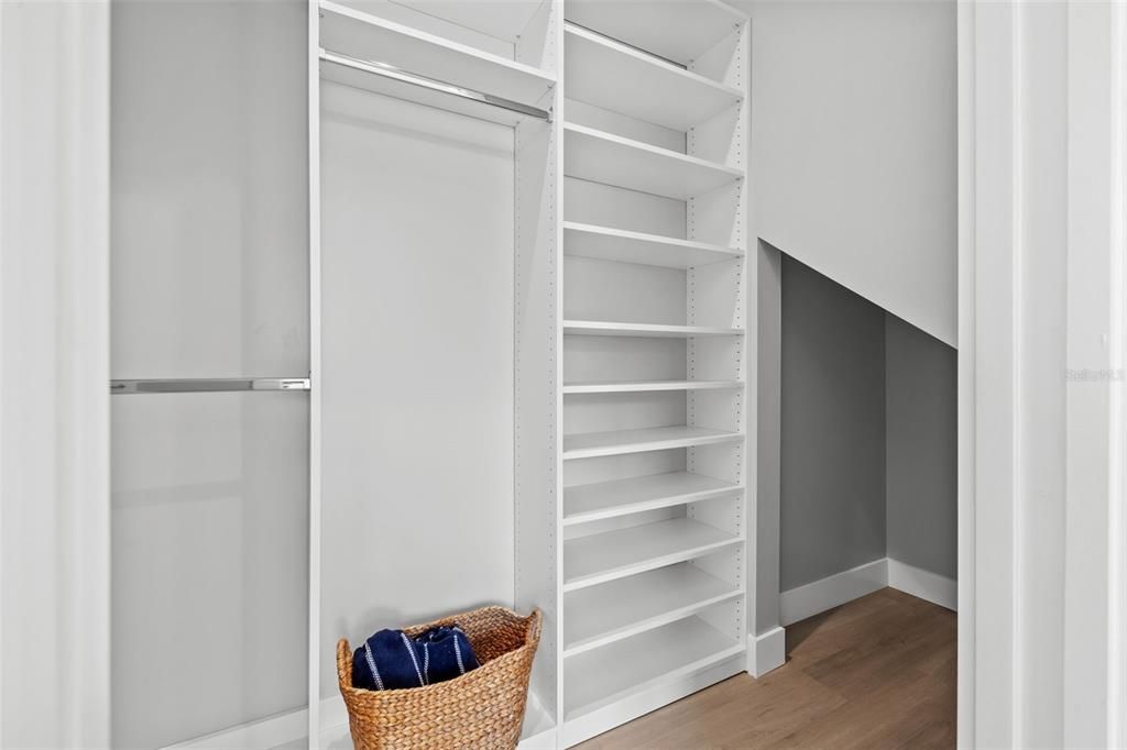 Large Walk in closet with under the stair storage