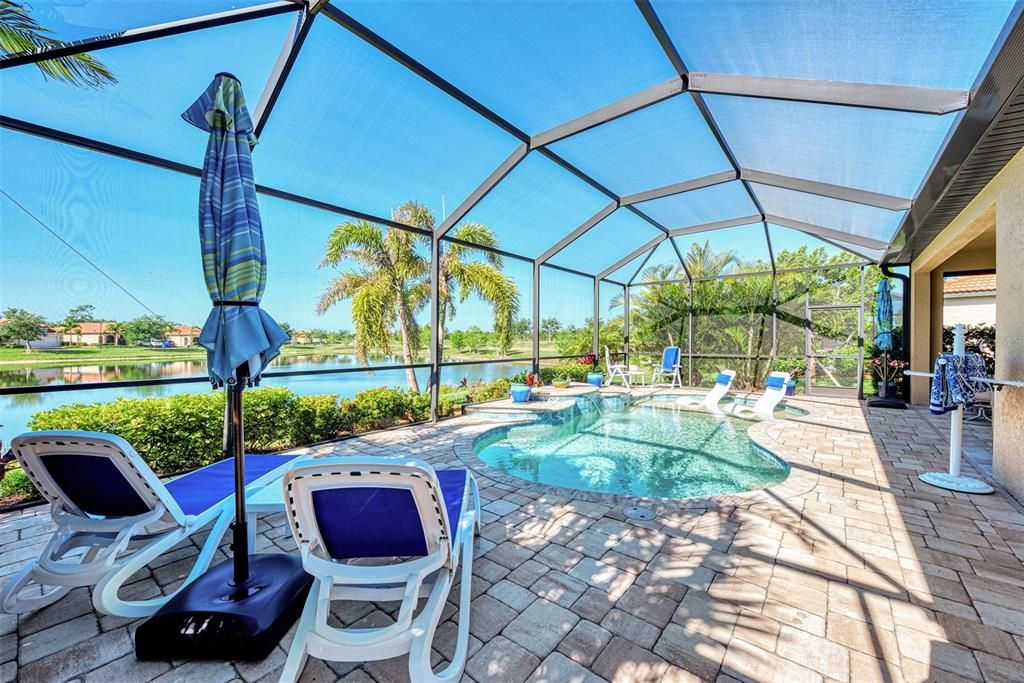 Lanai with pool, seating areas, and stunning water view