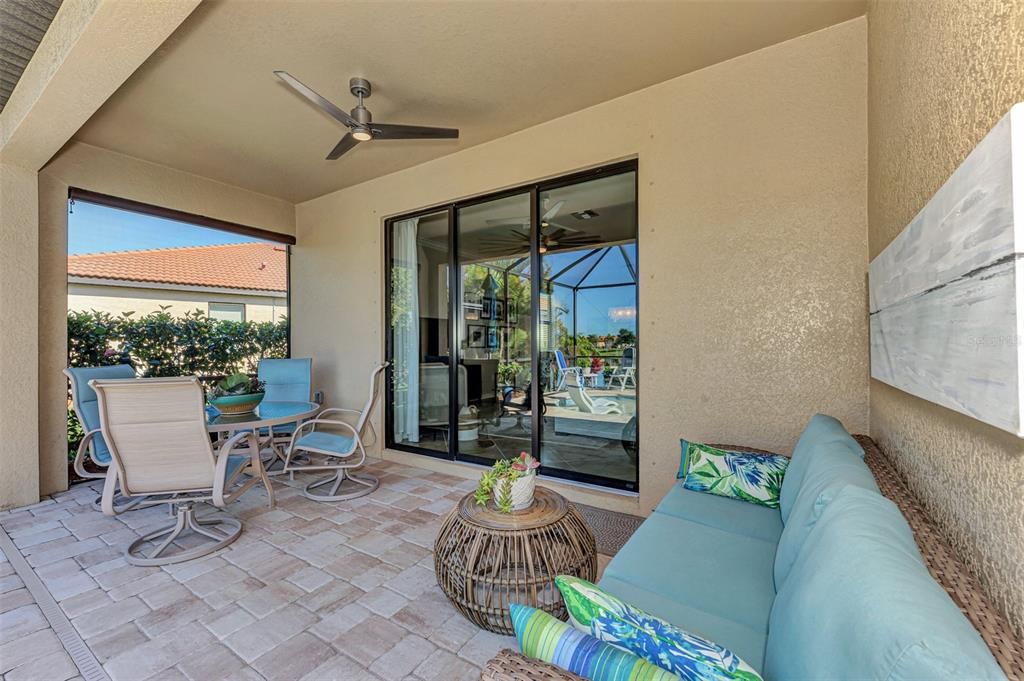 Lanai with pool, seating areas, and stunning water view