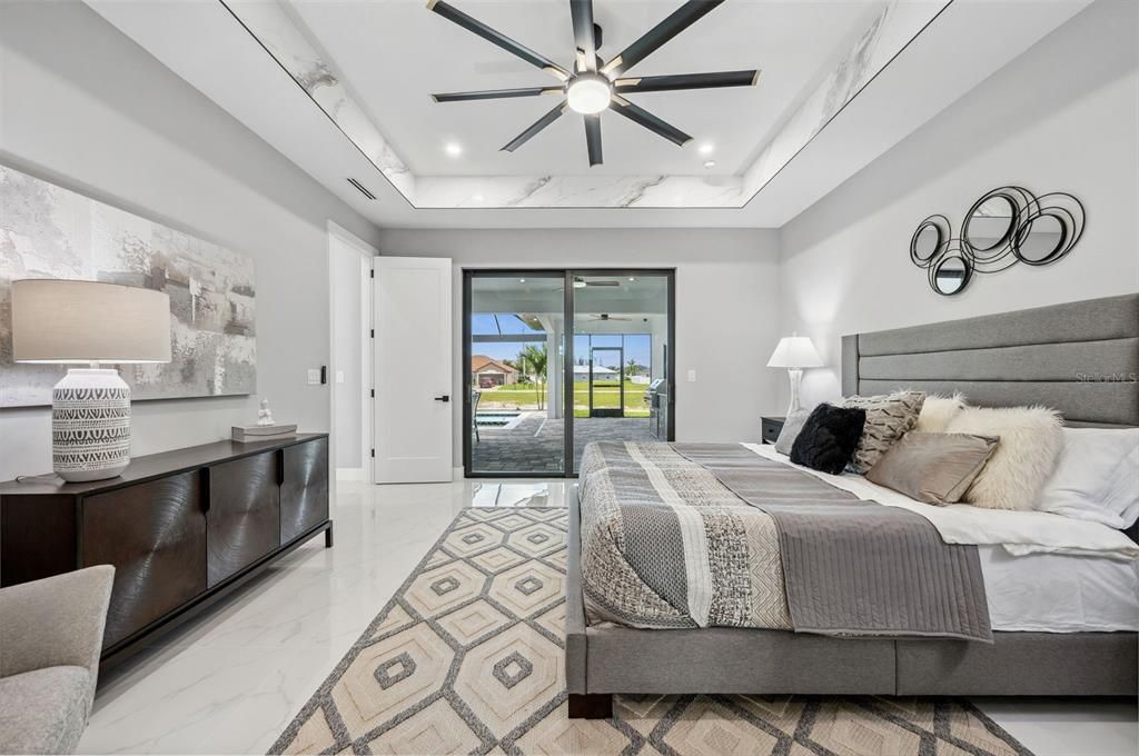 Master bedroom with a view of the pool