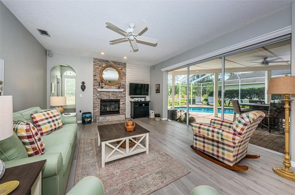 Spacious family room with pool and patio view