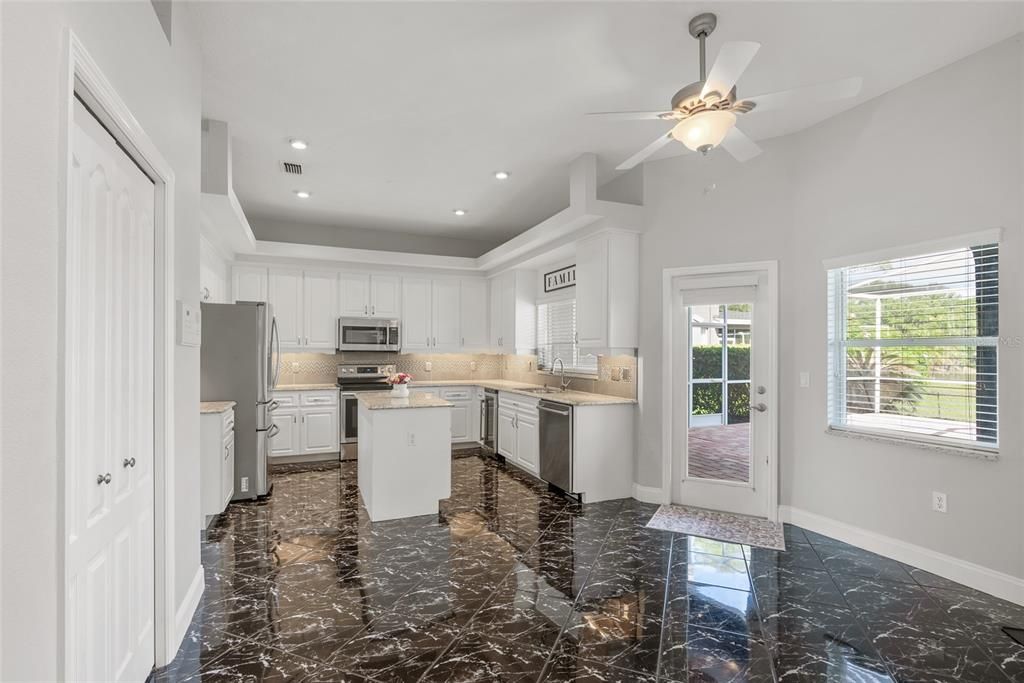 View of the Kitchen from the Dinette with French Door to Lanai.