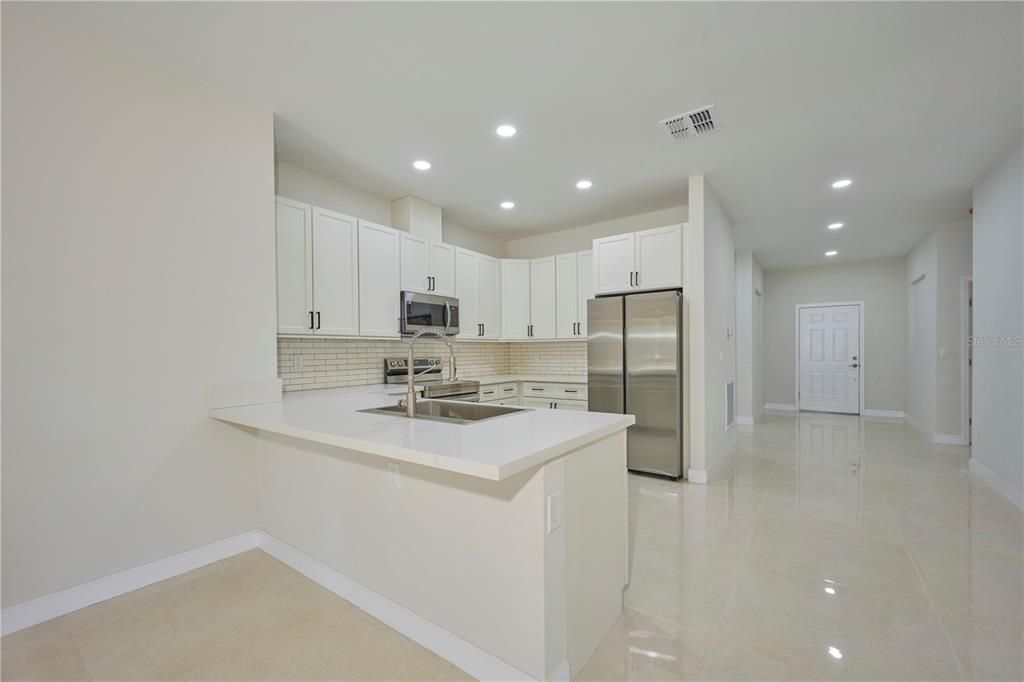 Handy breakfast bar for quick meals!  Door in rear is front entrance.