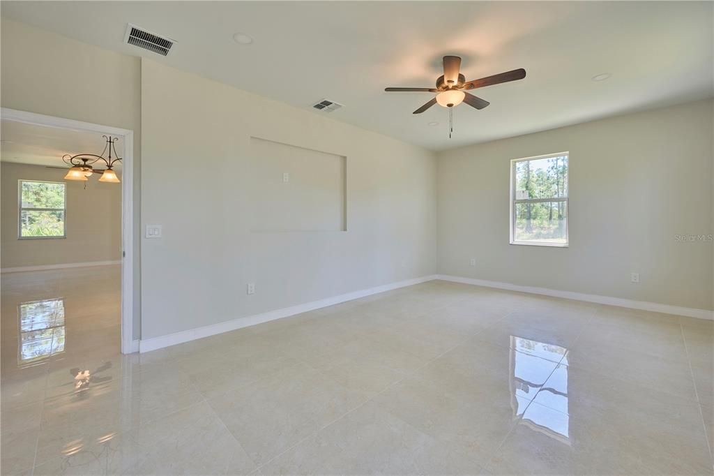 Reverse view of master bedroom showing niche in wall for a TV or decor