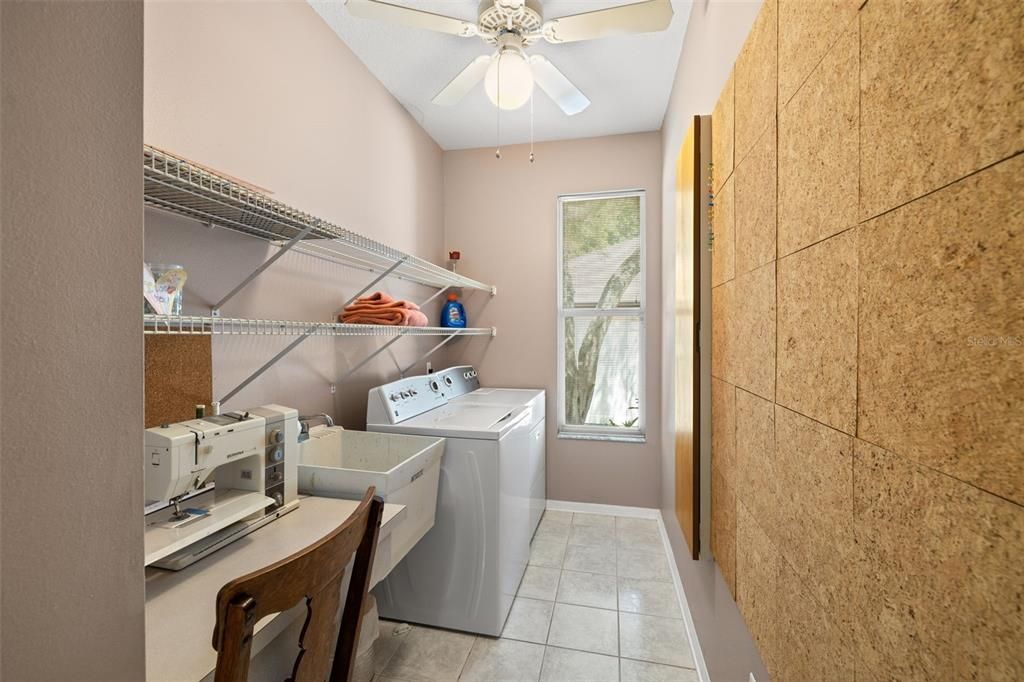 Large laundry room with space for a sewing machine and/or crafting.
