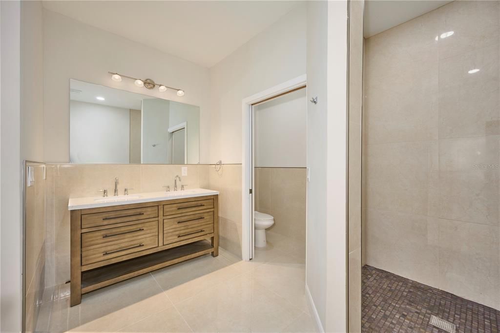 Ensuite features double sink vanity, water closet and shower