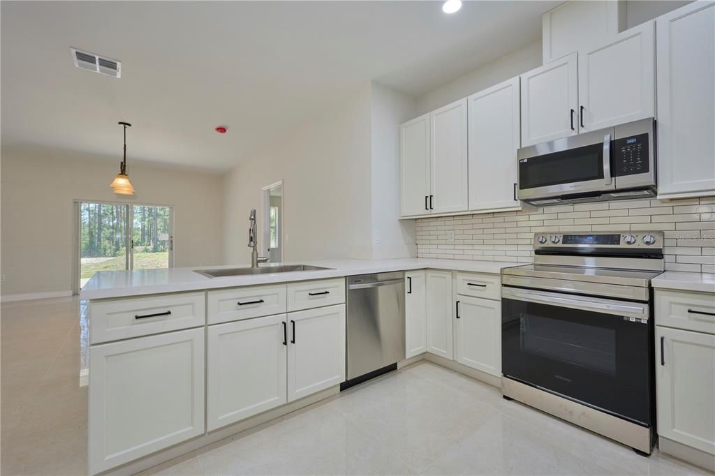 Gorgeous kitchen with stainless steel appliances and quartz countertops!