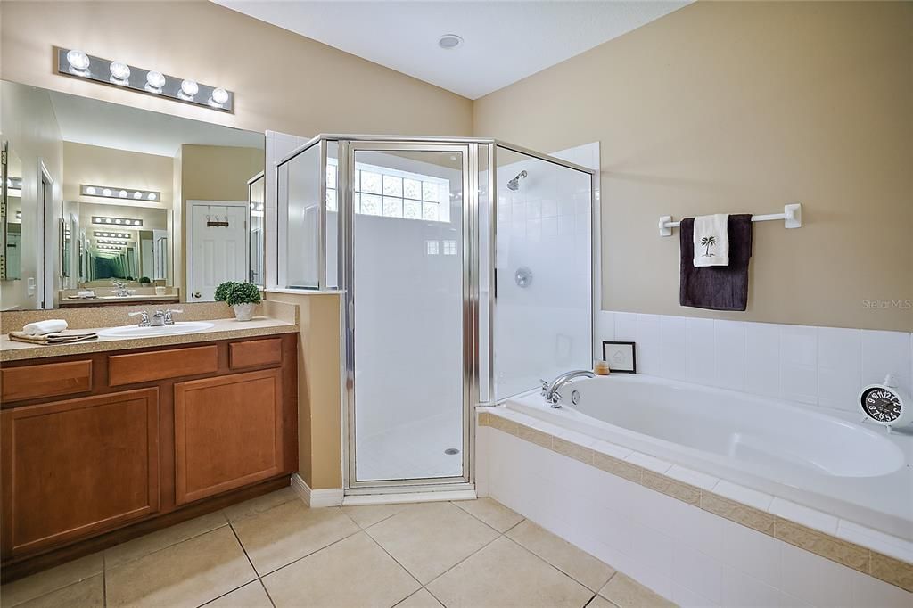 Primary Bathroom with Dual Sinks and Vanities and Walk-in Shower