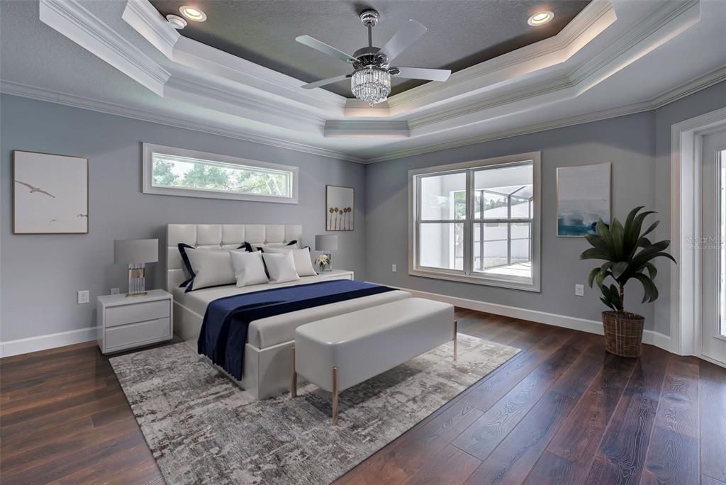 Virtually staged.  Drift off to sleep in the luxurious primary suite with its tray ceiling, beautiful lighting and easy access to the private lanai.